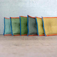 A series of rectangular sachets filled with lavender, arranged in a line with visible variations in color.