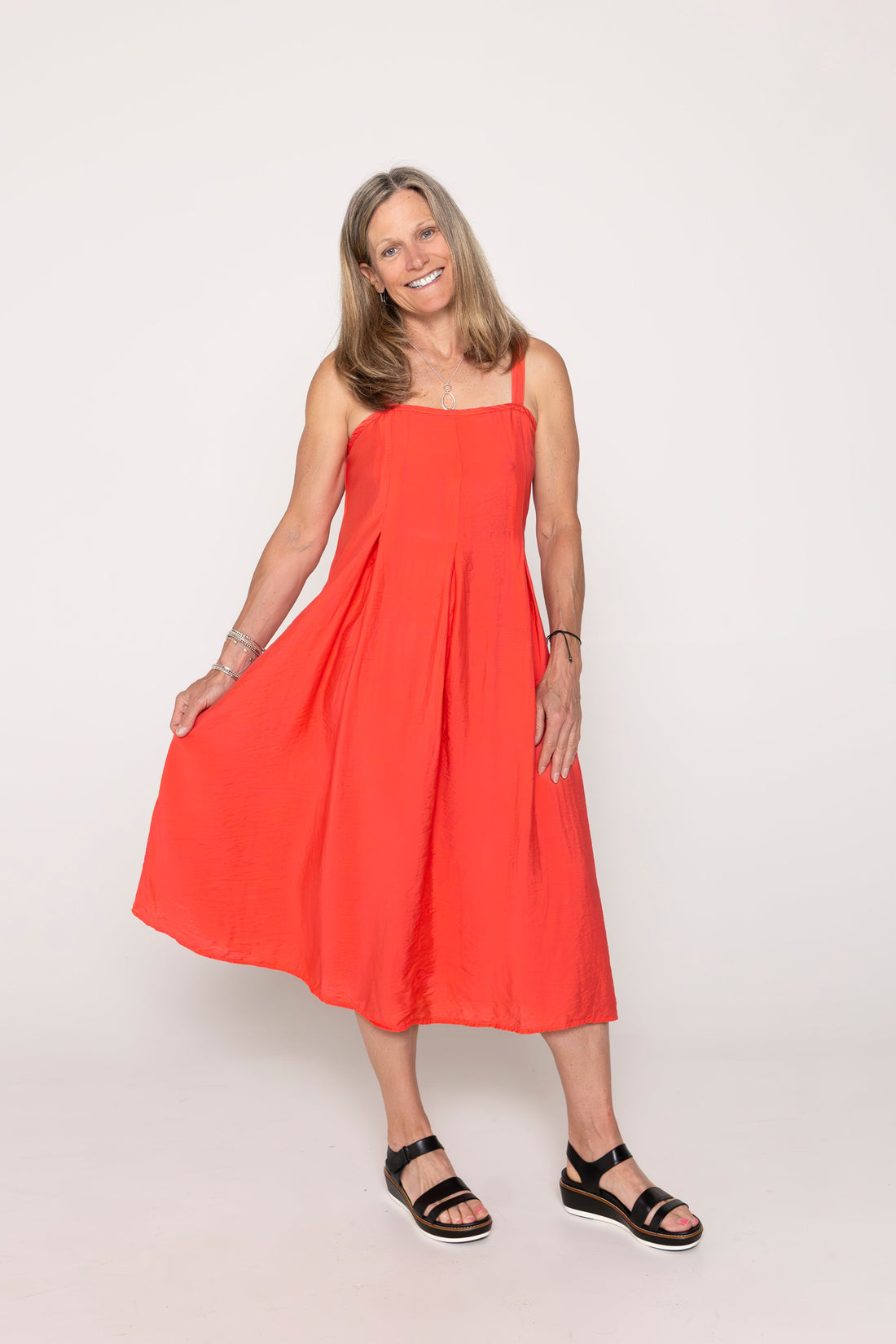 Woman wearing a red dress on a white background
