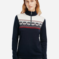 Person wearing a navy sweater with a patterned design on a white background
