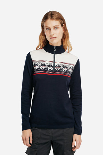 Person wearing a navy sweater with a patterned design on a white background