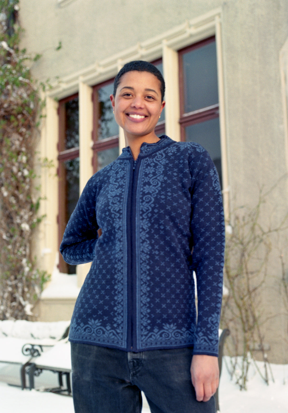 Person wearing a blue patterned jacket standing outdoors in winter.