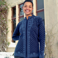 Person wearing a blue patterned jacket standing outdoors in winter.