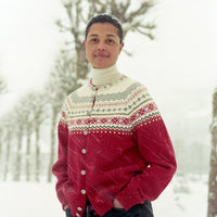Person wearing a red and white patterned sweater in a snowy landscape