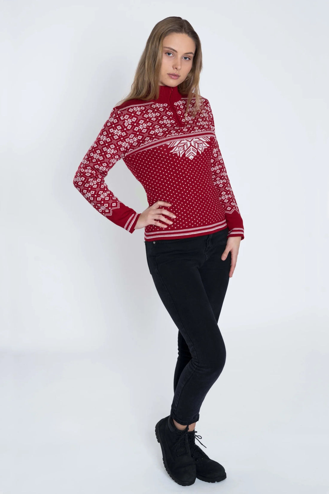 Woman wearing a red patterned sweater on a white background
