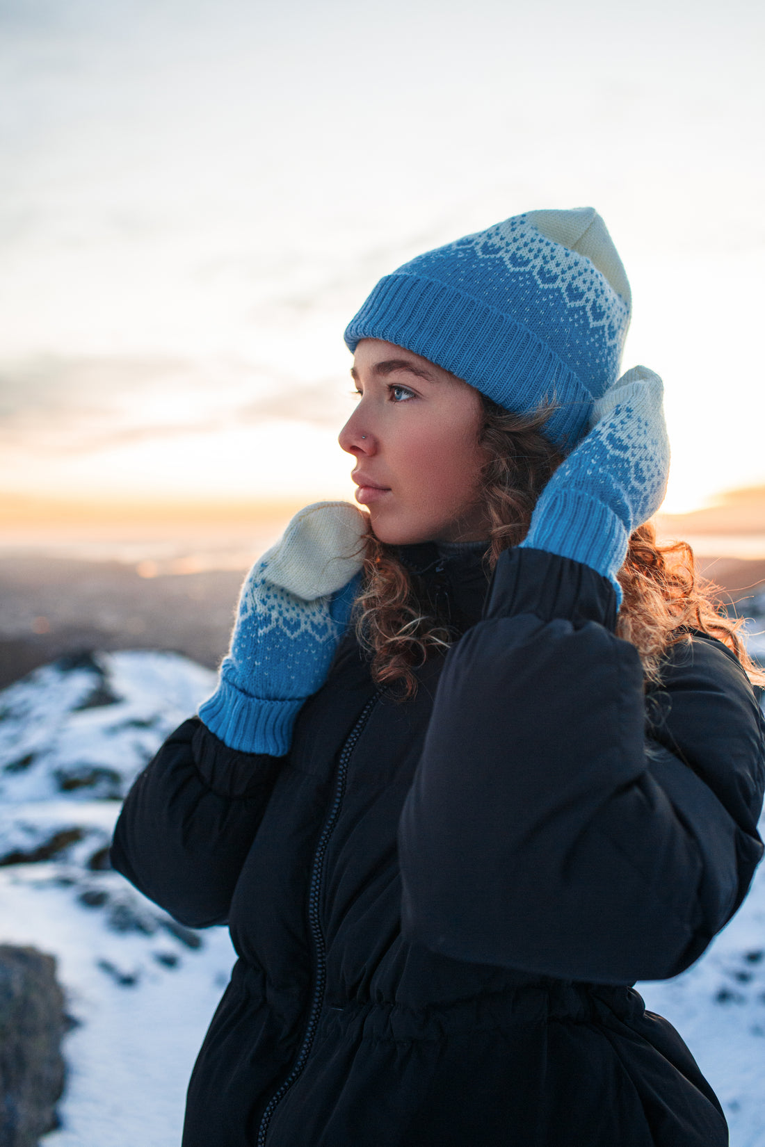 Model wears the Snow Storm Beanie in Blue on snowy background