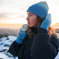 Model wears the Snow Storm Beanie in Blue on snowy background