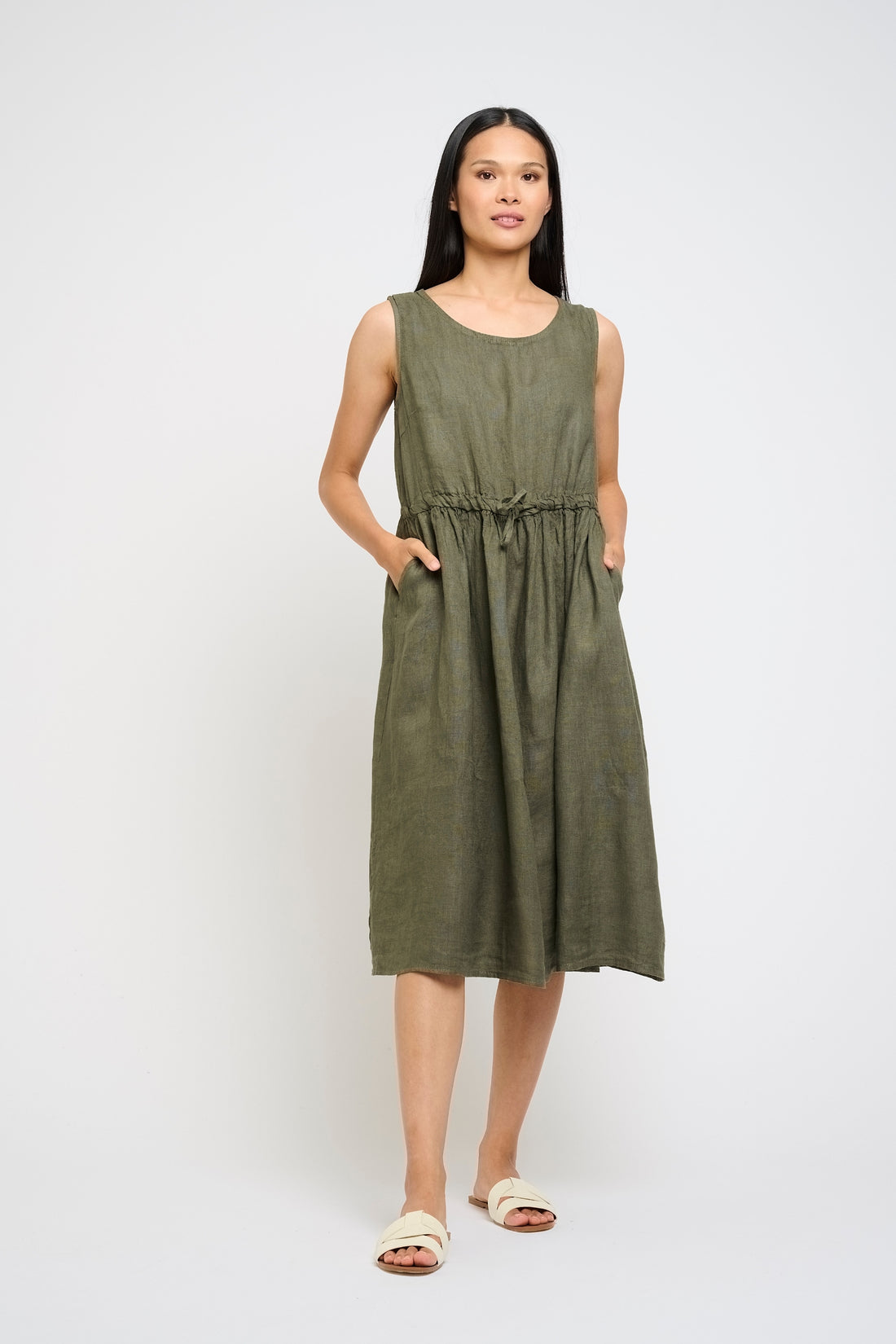 Woman wearing a green dress on a white background