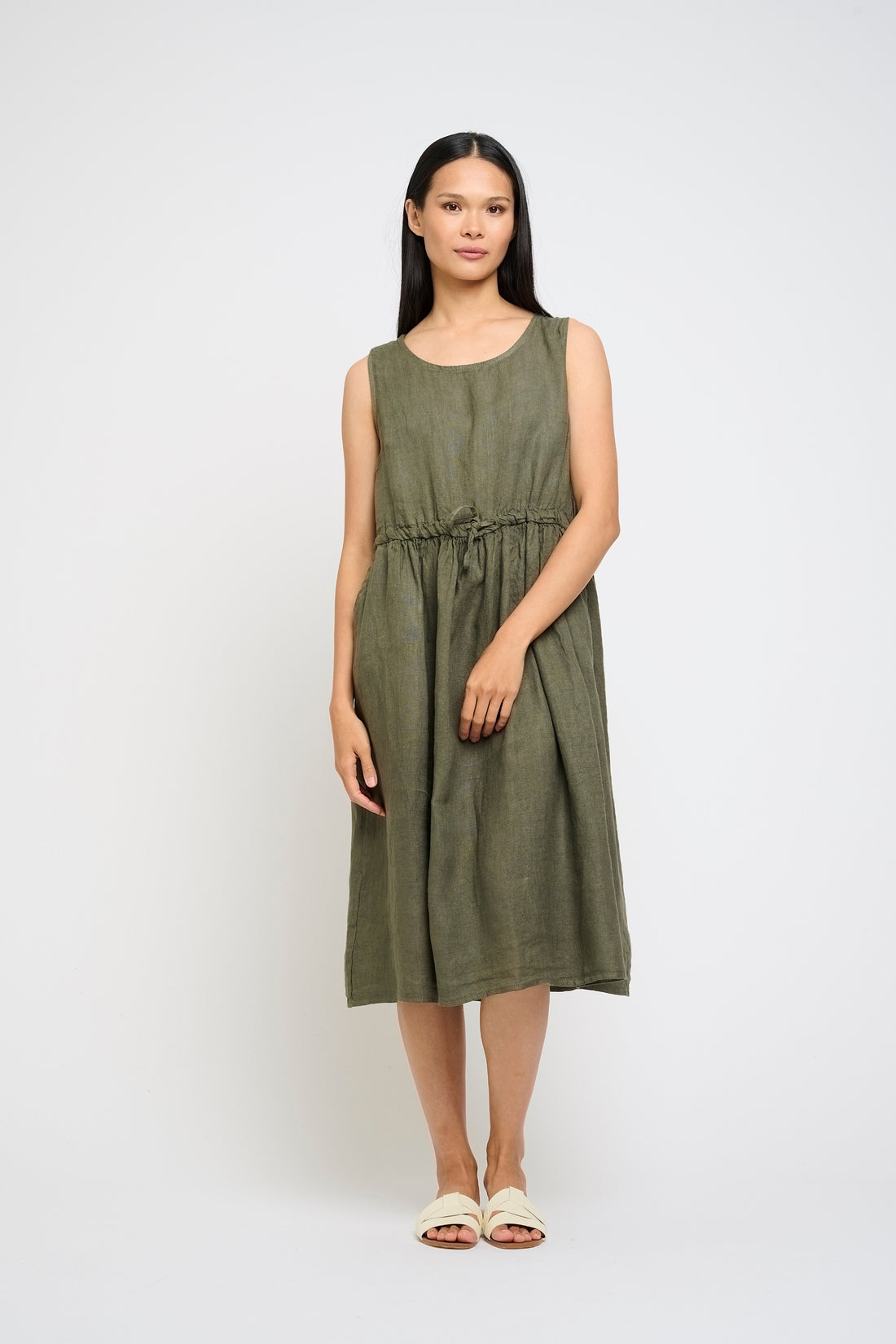 Woman wearing a green dress on a white background