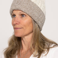 Woman wearing a two-tone beanie hat on a white background