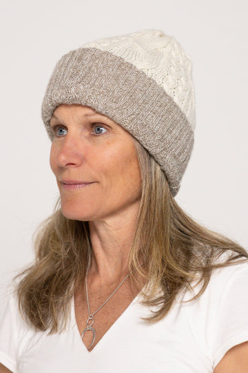 Woman wearing a two-tone beanie hat on a white background