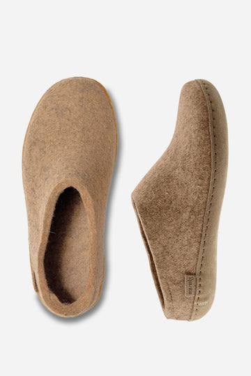 Pair of brown slippers on a light gray background