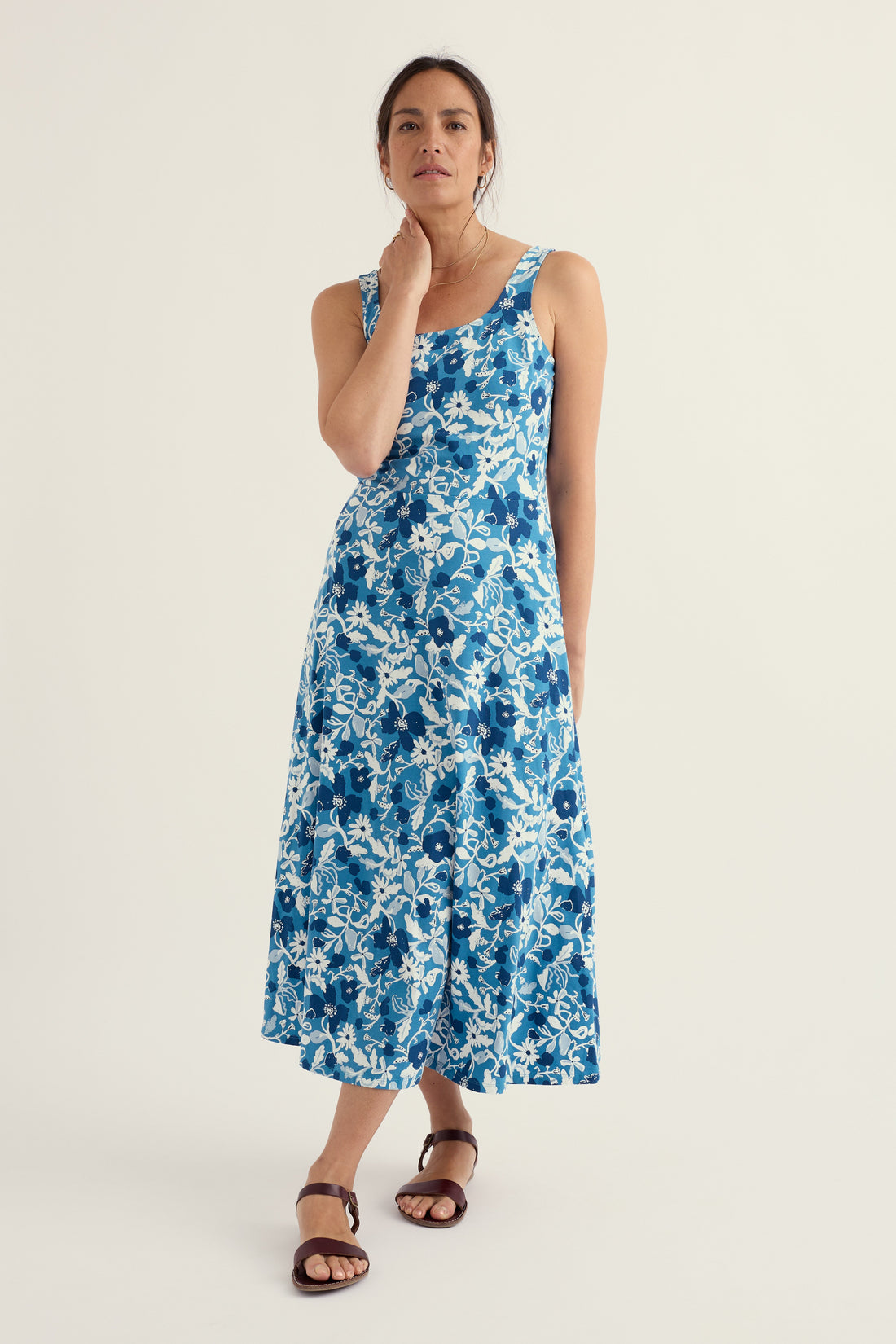 Woman wearing a blue floral dress on a white background