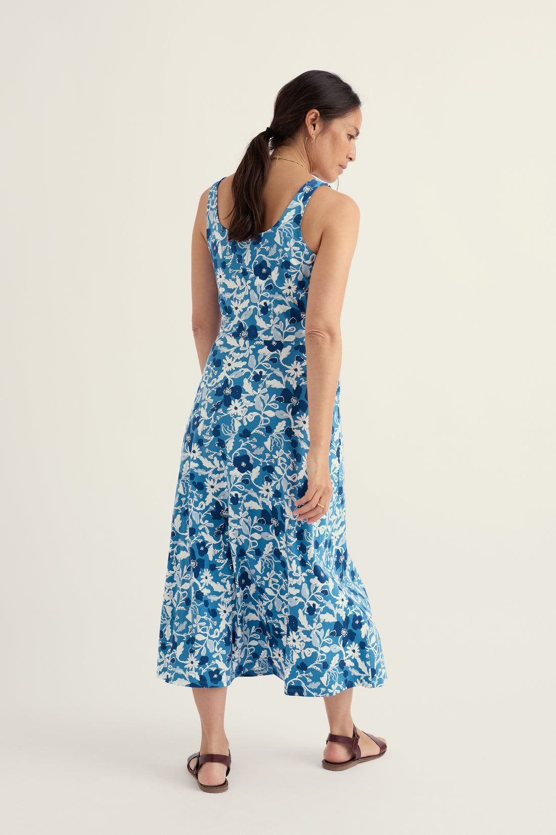 Woman wearing a blue floral dress on a white background