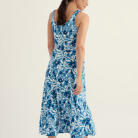 Woman wearing a blue floral dress on a white background