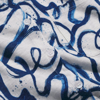Close-up of a shirt with blue abstract pattern on white background